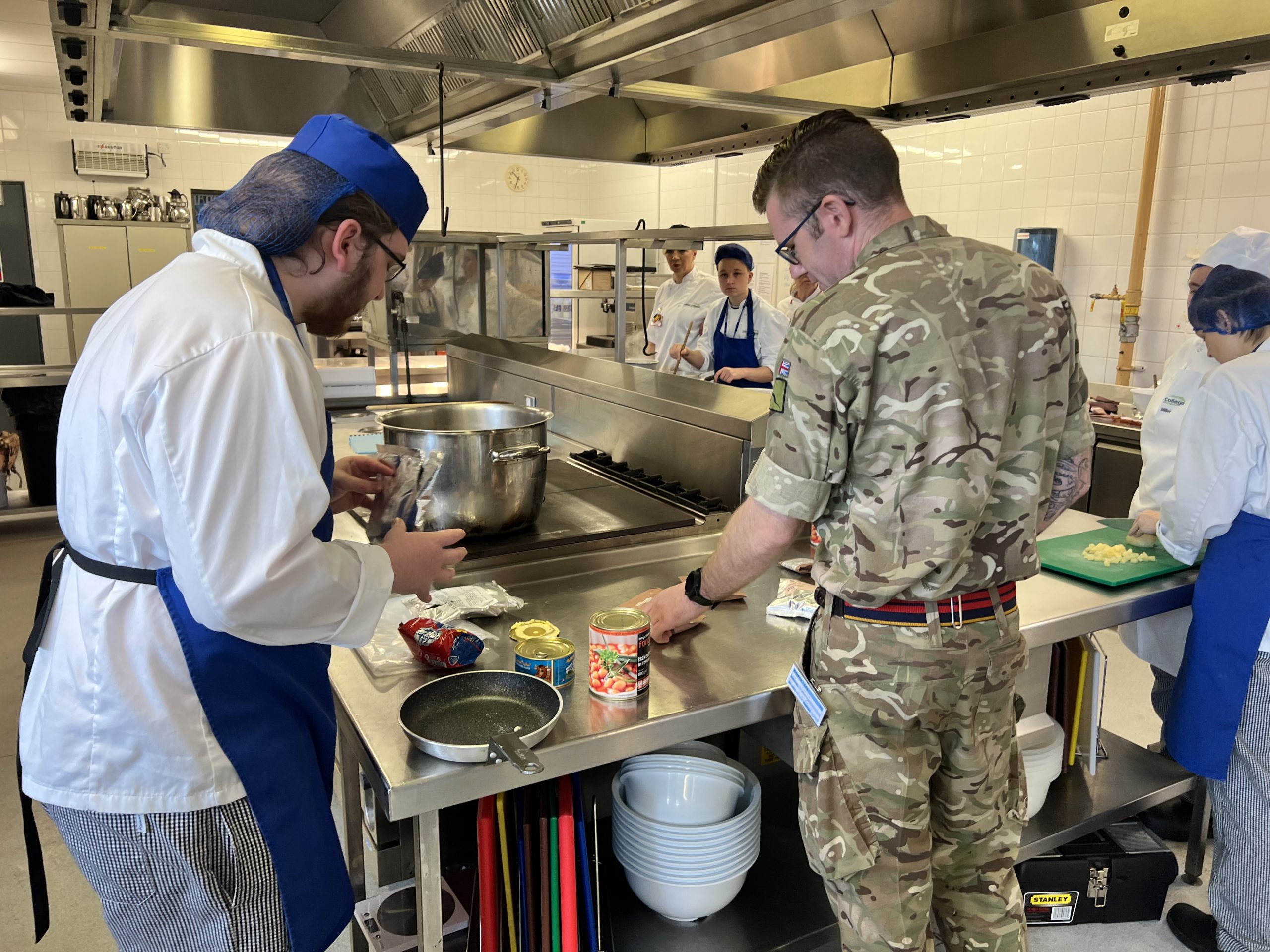 A student prepares ingredients with help