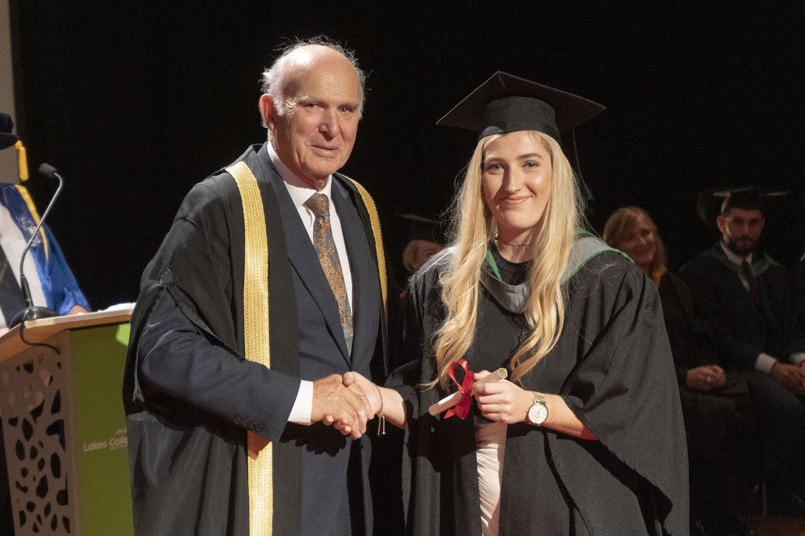 Sir Vince Cable, guest speaker at the graduation, shakes hands with graduate Sophie McSherry