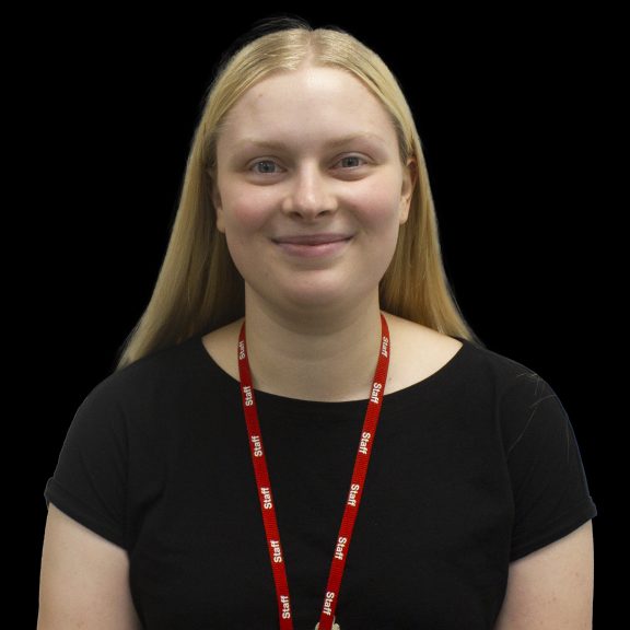 A woman smiles at the camera