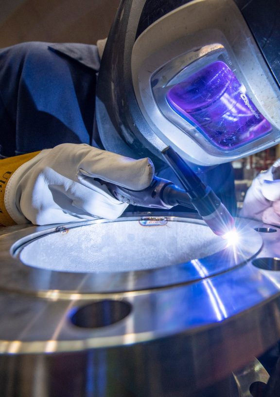 A worker wears PPE while carrying out their task