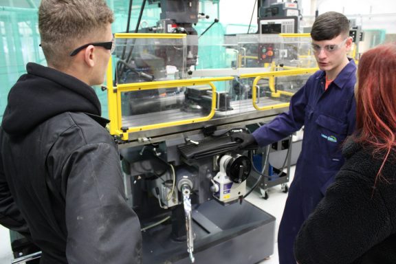 Apprentices showcase some of the machinery in the new Engineering Academy to an employer