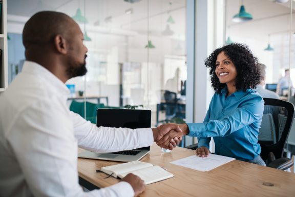 Smiling manager shaking hands with an applicant after an interview