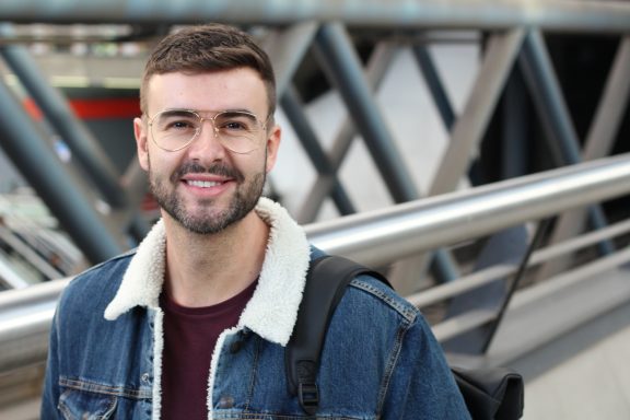 A man stands smiling at the camera